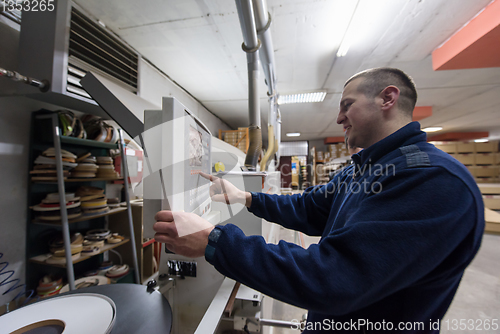 Image of carpenter calculating and programming a cnc wood working machine