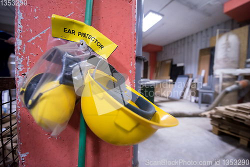 Image of standard security equipment yellow helmet and ears protection