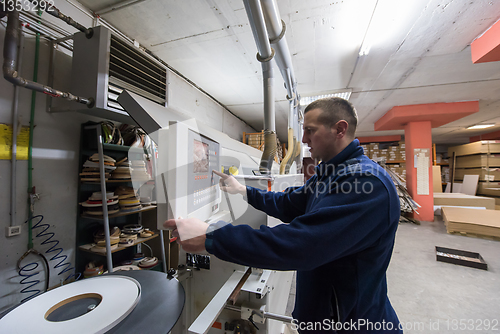 Image of carpenter calculating and programming a cnc wood working machine