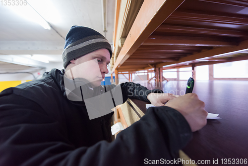 Image of carpenter writing a receipt