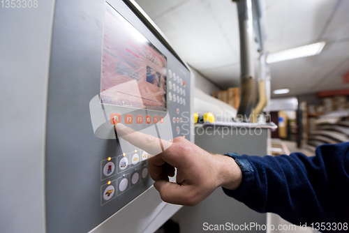 Image of carpenter calculating and programming a cnc wood working machine