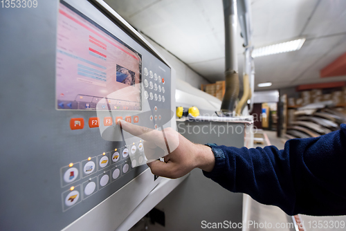 Image of carpenter calculating and programming a cnc wood working machine