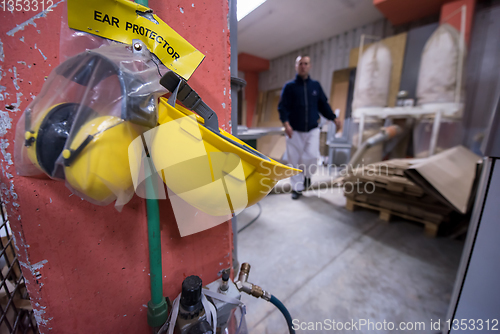 Image of standard security equipment yellow helmet and ears protection