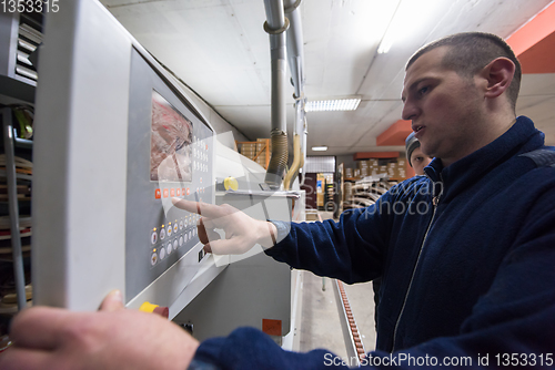 Image of carpenter calculating and programming a cnc wood working machine