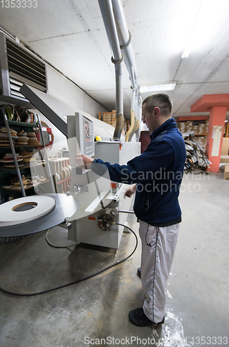 Image of carpenter calculating and programming a cnc wood working machine