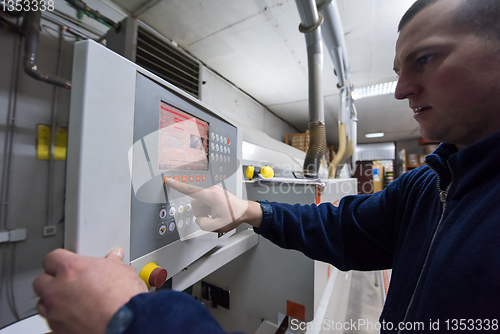 Image of carpenter calculating and programming a cnc wood working machine