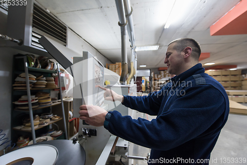 Image of carpenter calculating and programming a cnc wood working machine