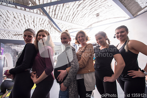 Image of portrait of a group sporty women with pregnant friend