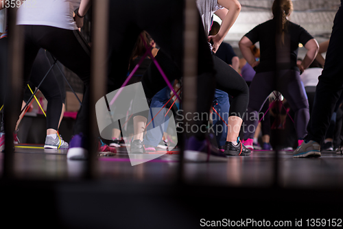 Image of sporty women exercising with a rubber bands