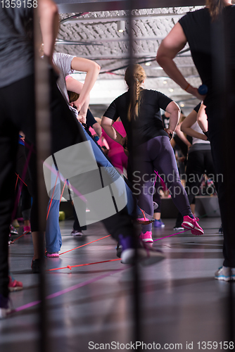 Image of sporty women exercising with a rubber bands