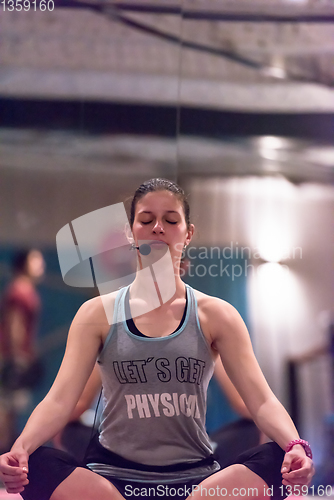 Image of sportswoman doing yoga exercise and meditating