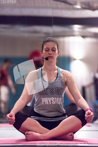 Image of sportswoman doing yoga exercise and meditating