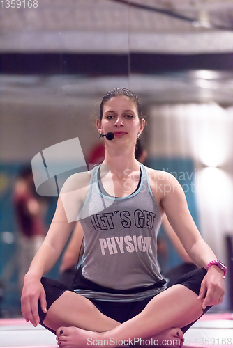 Image of sportswoman doing yoga exercise and meditating