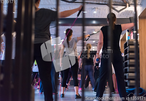 Image of sporty women exercising with a rubber bands