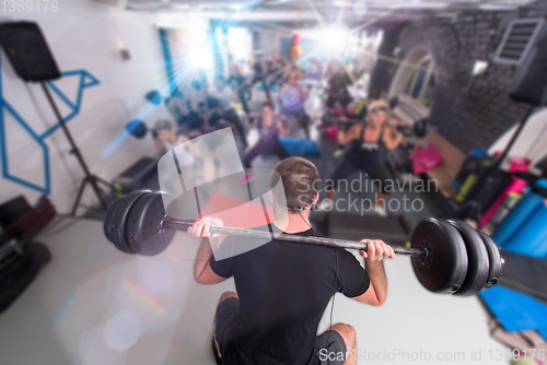 Image of sporty women using barbells while exercises