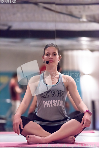 Image of sportswoman doing yoga exercise and meditating