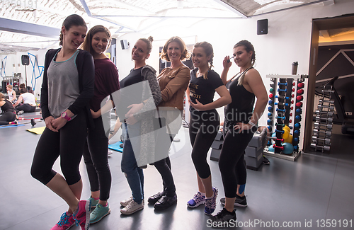 Image of portrait of a group sporty women with pregnant friend