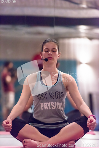 Image of sportswoman doing yoga exercise and meditating