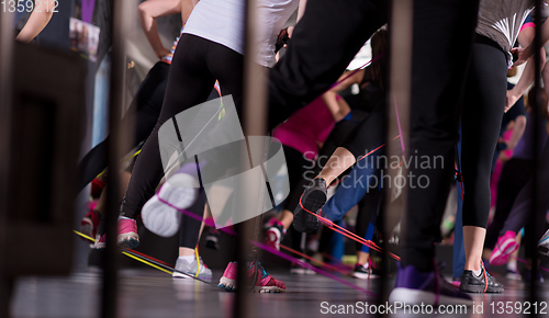 Image of sporty women exercising with a rubber bands