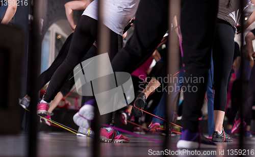 Image of sporty women exercising with a rubber bands