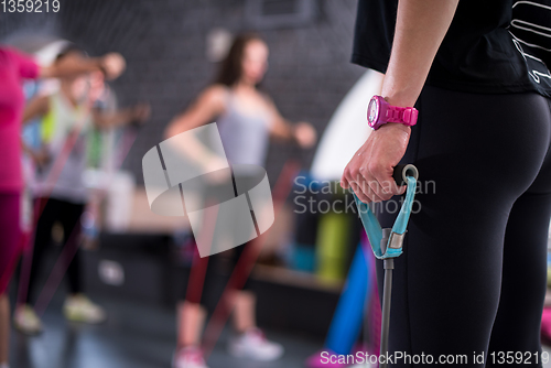 Image of sporty women exercising with a rubber bands