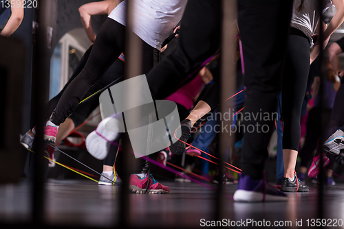 Image of sporty women exercising with a rubber bands