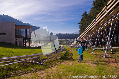 Image of Happy family enjoying alpine coaster