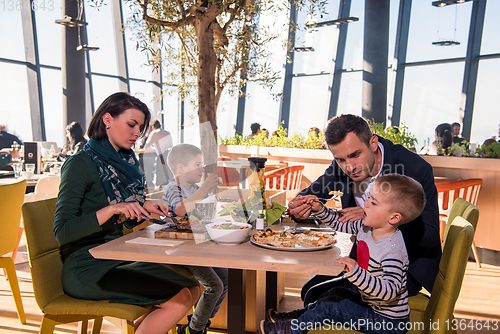 Image of happy family enjoying lunch time together
