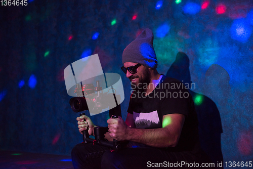 Image of videographer in neon disco party