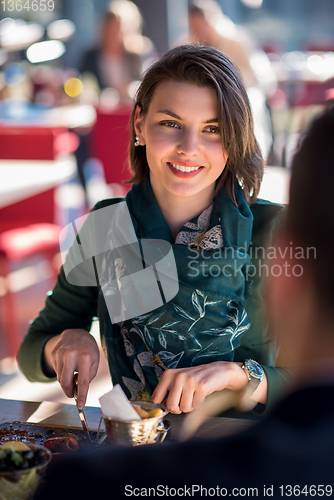 Image of youn couple enjoying lunch at restaurant