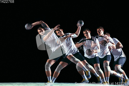 Image of Young handball player against dark studio background in strobe light