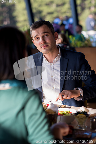 Image of youn couple enjoying lunch at restaurant