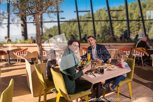 Image of happy family enjoying lunch time together