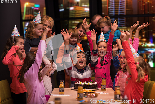 Image of happy young boy having birthday party