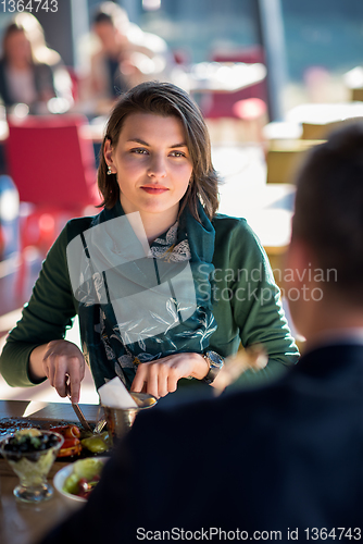 Image of youn couple enjoying lunch at restaurant