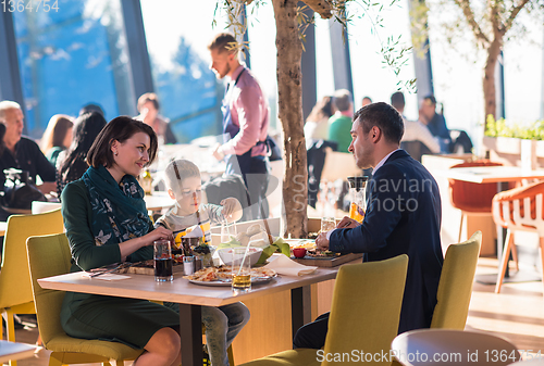 Image of happy family enjoying lunch time together