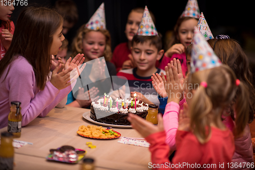 Image of The young boy joyfully celebrating his birthday