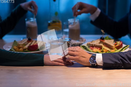 Image of loving couple enjoying romantic dinner