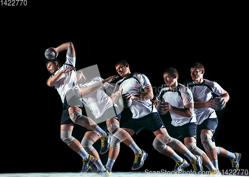 Image of Young handball player against dark studio background in strobe light