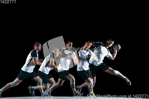 Image of Young handball player against dark studio background in strobe light