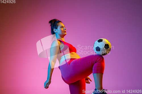 Image of Young caucasian plus size female model\'s training on gradient background