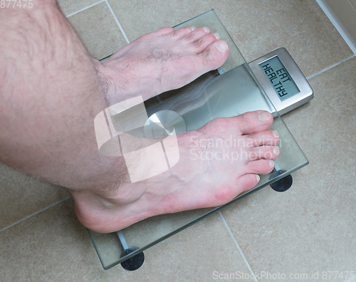 Image of Man\'s feet on weight scale - Eat healthy