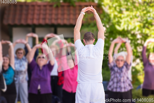 Image of trainer training motivated active healthy senior people