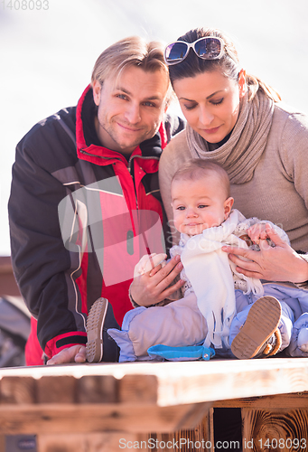 Image of young happy family with little child enjoying winter day