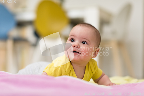 Image of newborn baby boy playing on the floor