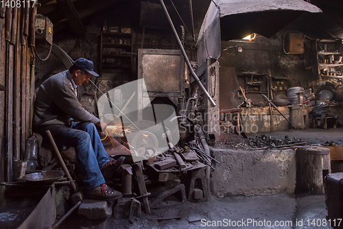 Image of the blacksmith polishing metal products