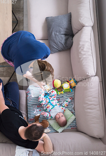 Image of top view of happy mother and father taking picture of baby