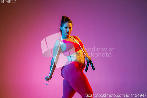 Image of Young caucasian plus size female model\'s training on gradient background