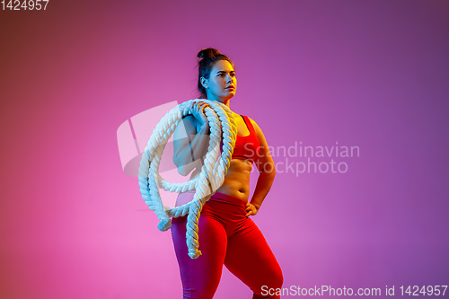 Image of Young caucasian plus size female model\'s training on gradient background