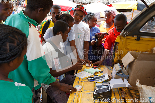 Image of Man sell cellular phones on rural Madagascar marketplace